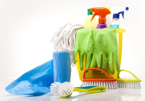 Trained carpet cleaner using professional equipment in a safe environment